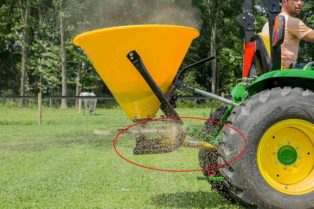 Tractor PTO shaft driving a fertilizer spreader gearbox in agricultural applications
