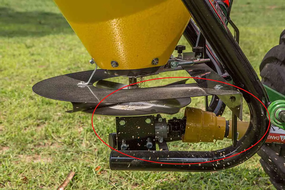 Tractor PTO shaft driving a fertilizer spreader gearbox in agricultural applications
