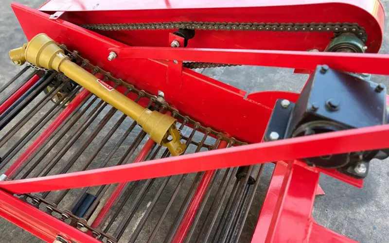 Chain and sprocket drive mechanism on a potato harvesting machine